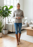 Woman standing in a modern living room with plants and furniture.